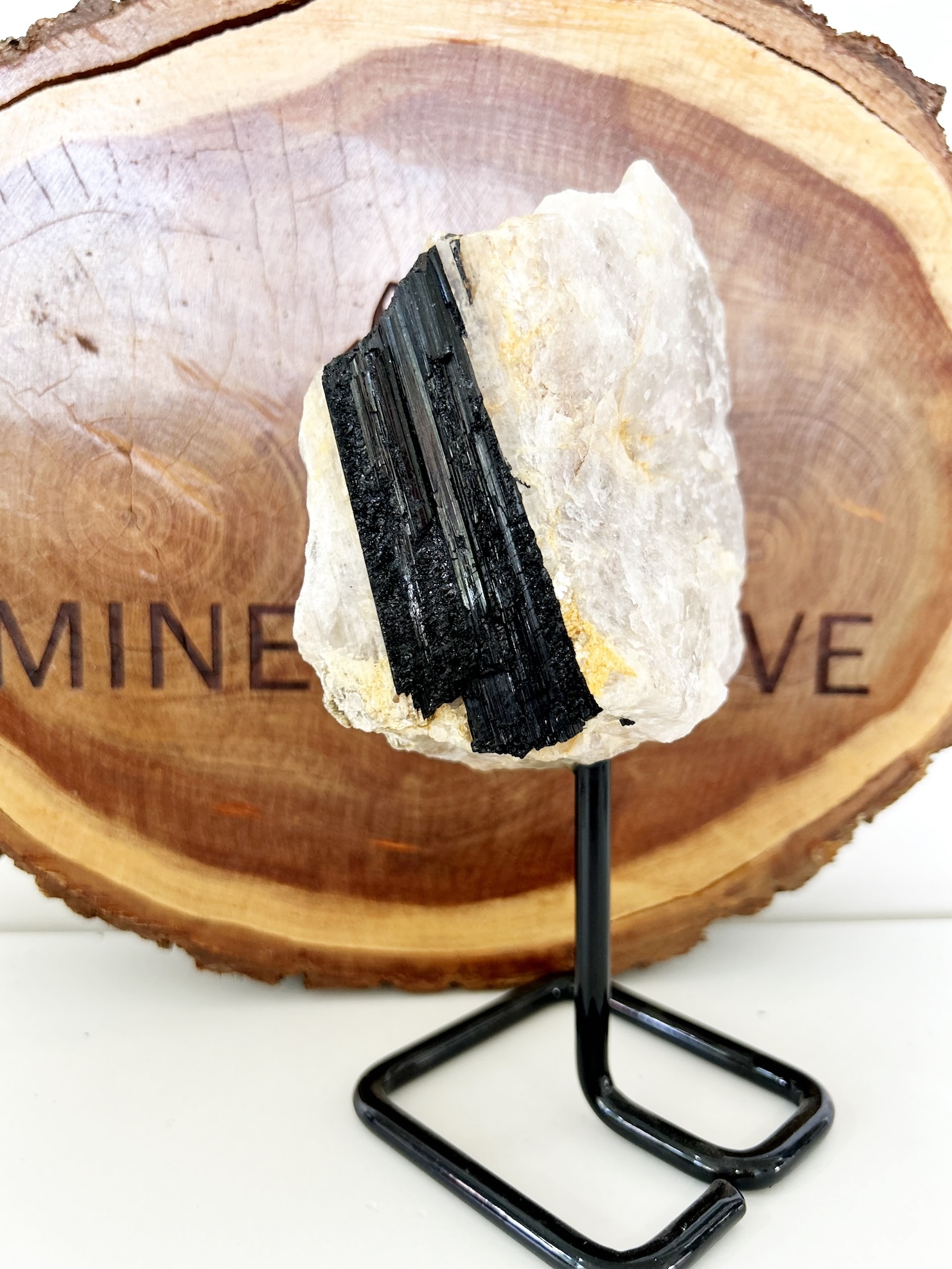clear quartz and tourmaline on a stand